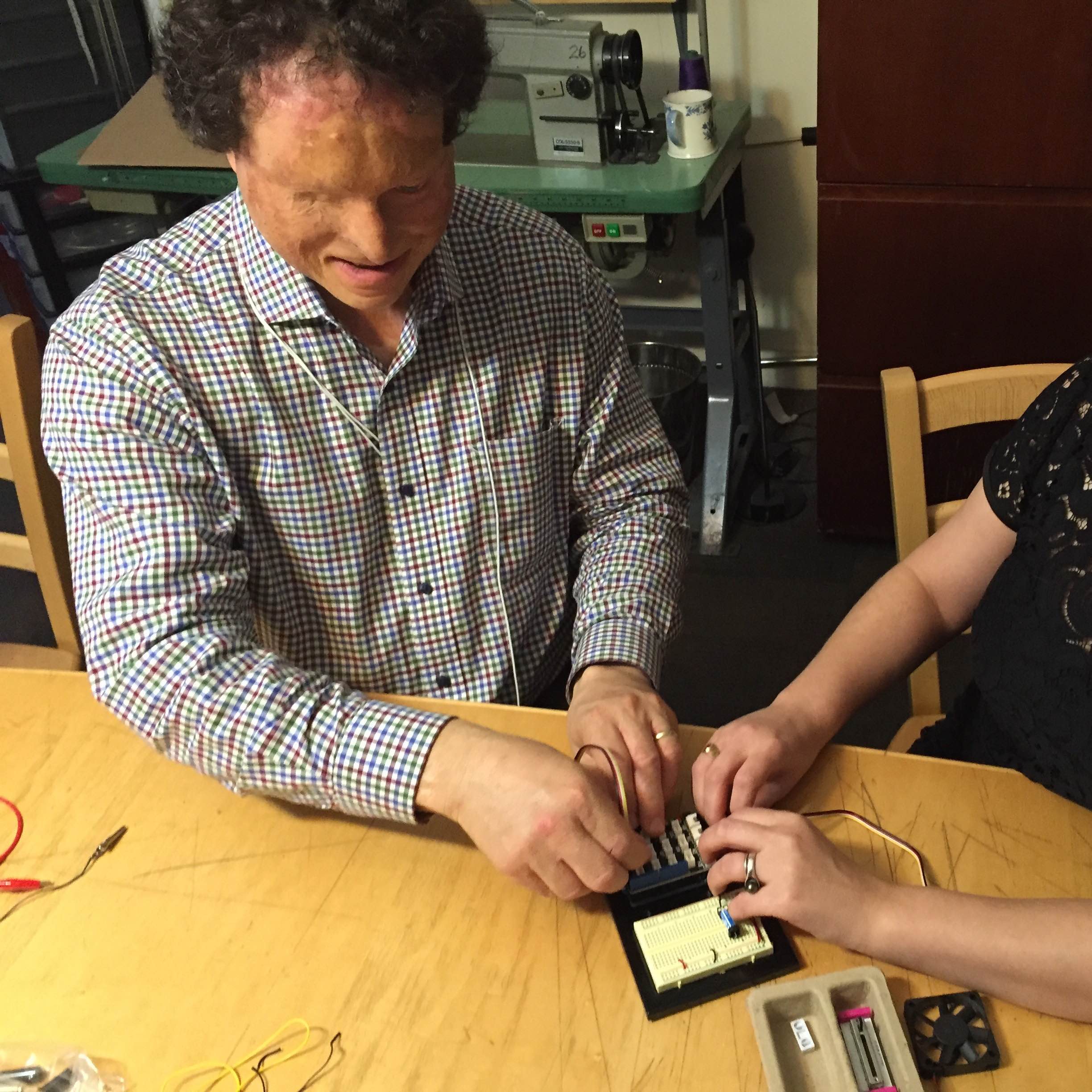 Image of Dr. Miele working with an Arduino board